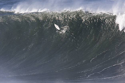 How big is big? The board on this wave is 10 ft. The surfer is praying he makes it through.